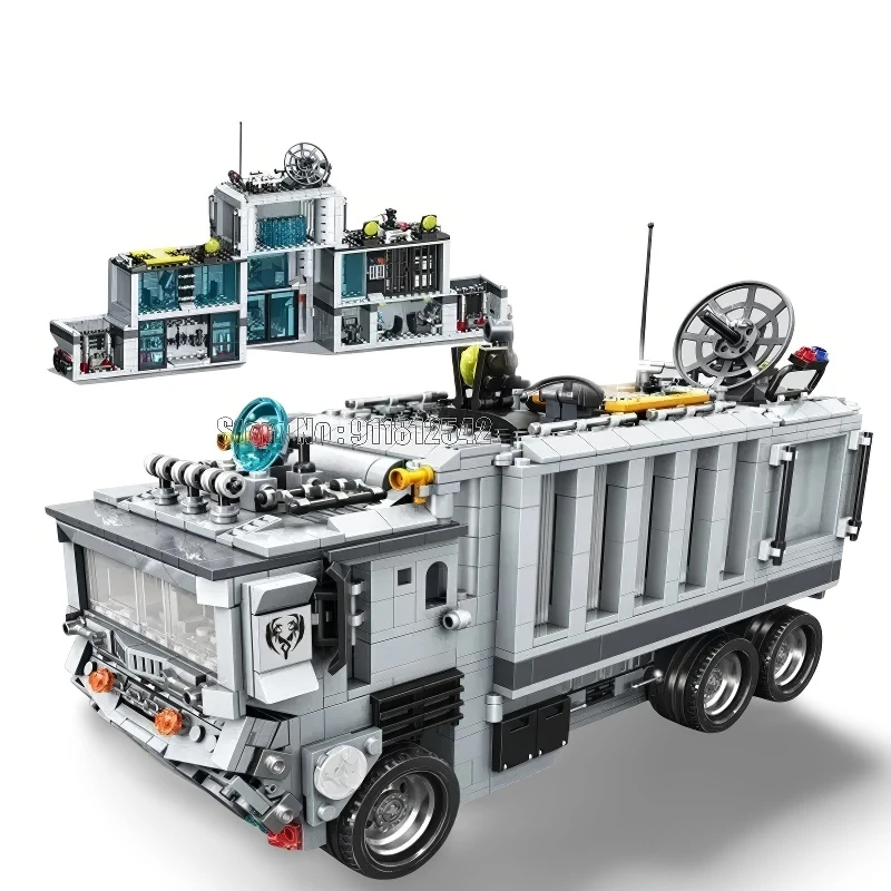 A gray toy truck with a building on top and a separate building behind it.