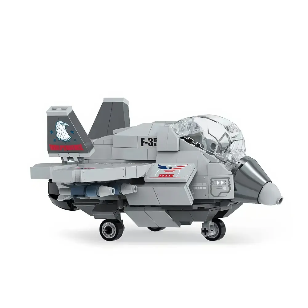 A gray brick toy jet with a clear cockpit, eagle and flag decals, and black wheels.