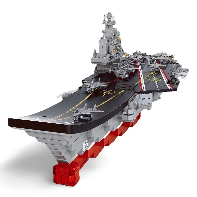 A toy aircraft carrier with several toy planes and helicopters on its deck.