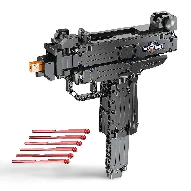A black toy gun with a gold-colored tip and several red projectiles is displayed.